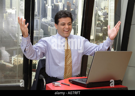 Boss happy message on laptop computer in his cabin with city background - MR# Stock Photo