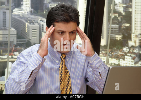 CEO serious seeing message on laptop computer in his cabin Stock Photo