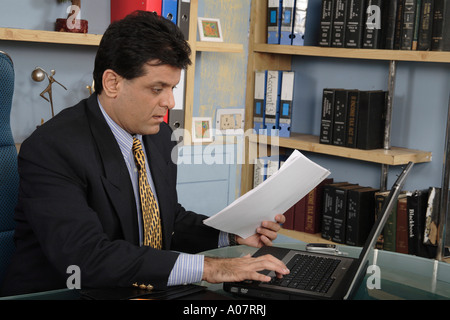 CEO working on computer in his office cabin in business suit Stock Photo