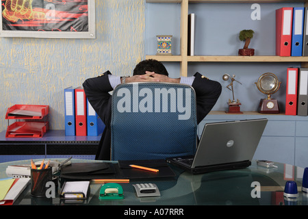 CEO relaxing looking at the wall in his office cabin in business suit - MR# Stock Photo