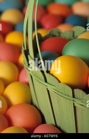 Colorful eggs in green wooden basket close up Easter Stock Photo