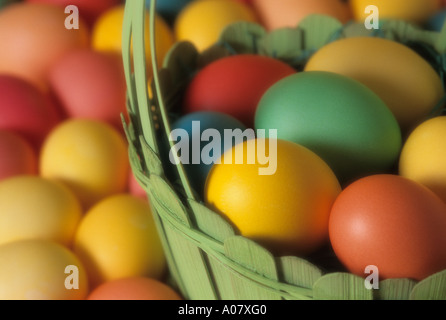 Colorful eggs in green wooden basket close up Easter Stock Photo