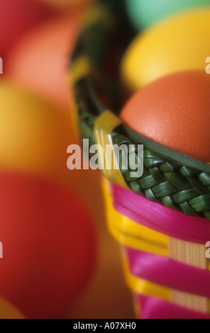 Colorful eggs in green pink yellow basket at Easter Stock Photo