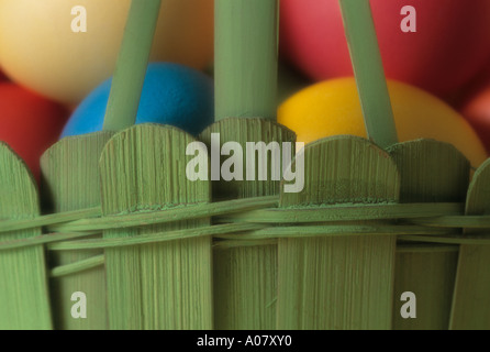 Colorful eggs in green wooden basket close up Easter Stock Photo