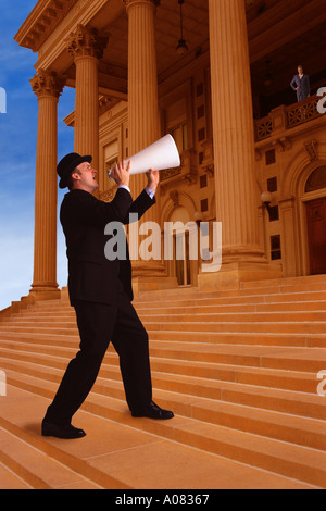 Businessman shouting through megaphone Stock Photo