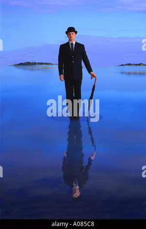 Businessman standing on water Stock Photo
