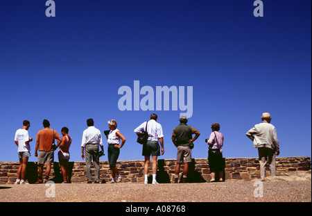 people standing on a wall and looking in the valley sight tourists curious view overlooking Stock Photo