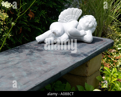 An angel as a garden decoration in an urban garden Stock Photo
