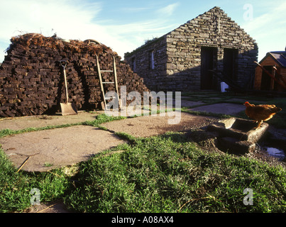 dh Farm museum CORRIGALL ORKNEY Stack of peat hen drinking from trough agricultural tourist attraction