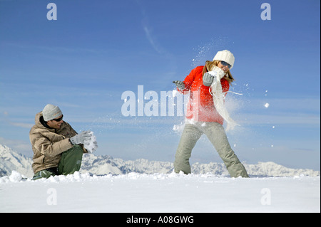 Junges Paar hat Spass bei einer Schneeballschlacht, young couple enjoying snowball fight Stock Photo