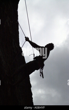 Silhouette of a climber hanging in the rope Elbe Sandstone Mountains Labske Piskovce Czech Republic Stock Photo