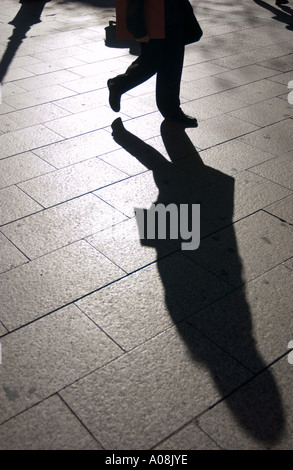 Shadow of a mysterious Anonymous man walking down a street in New York ...