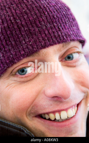caucasian man wearing wool cap smiles into camera Stock Photo
