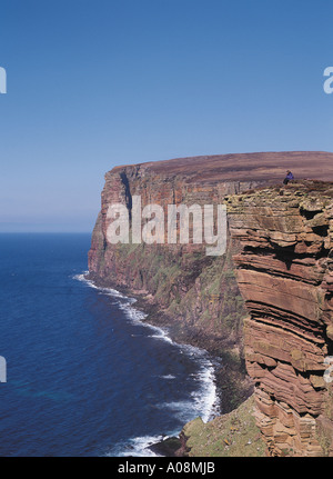 dh St Johns Head HOY ORKNEY Tourist sitting overlooking seacliffs West coast of Hoy