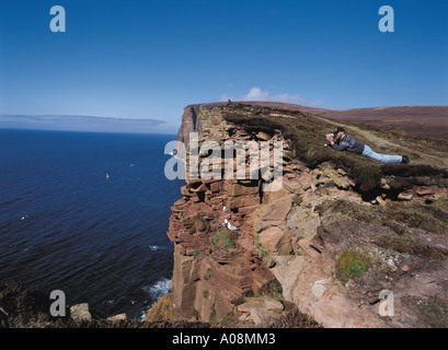 dh St Johns Head HOY ISLAND ORKNEY Tourist videoing sea birds cliffs binoculars cliff man bird watcher edge people scotland