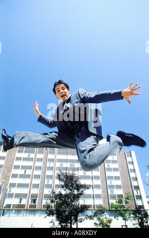 Young man jumping up in the air with excitement Stock Photo