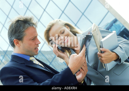 Young professionals reading a magazine together Stock Photo