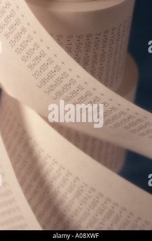 Adding machine tape abstract spiraling endless rows of large numbers. Stock Photo