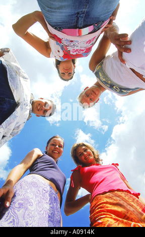 Portrait of a group of young people looking down smiling Stock Photo