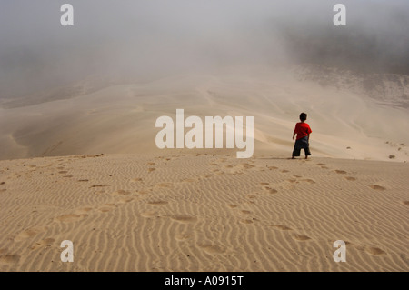 Boy Standing on Sand Dunes, Siuslaw National Forest, Oregon, USA Stock Photo