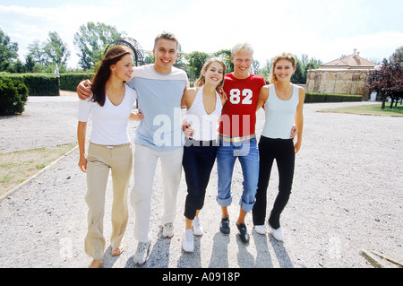 Portrait of a man walking arm in arm with four women Stock Photo