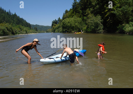 Family in Lake With Canoe Stock Photo