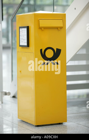 Gelber Briefkasten im Flughafen Muenchen, yellow letter box at Munich airport Stock Photo