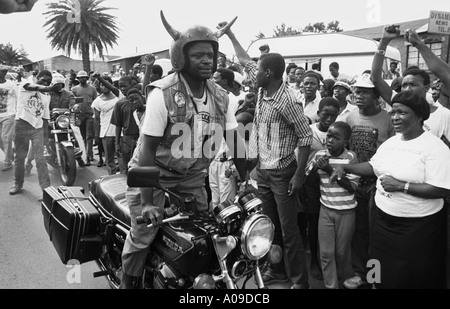 South Africa. Soweto. Crowds celebrating Nelson Mandela's release from prison and awaiting his return outside his home. Man on motor cycle. Stock Photo