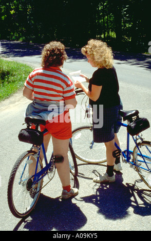 Aunt and niece age 49 and 26 checking map on family bike trip. Door County Wisconsin USA Stock Photo