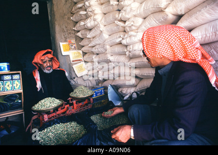 Saudi Arabia, Asir Province. Merchant in Khamis Mushayt selling beans Stock Photo
