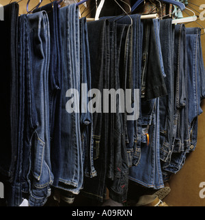 a selection of jeans hanging in a wardrobe Stock Photo