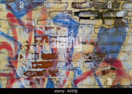 Graffiti on a brick wall forms an abstract design. Background textures and patterns Stock Photo
