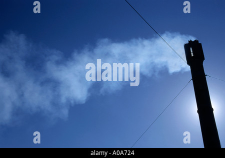 Smoke billowing from the chimney of a lavender factory. Stock Photo