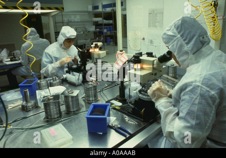 Workers in clean room checking computer chips during the manufacturing process Stock Photo