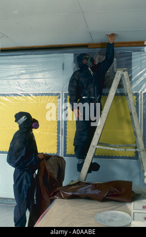Workers remove abestos ceiling tile in Virginia school Stock Photo