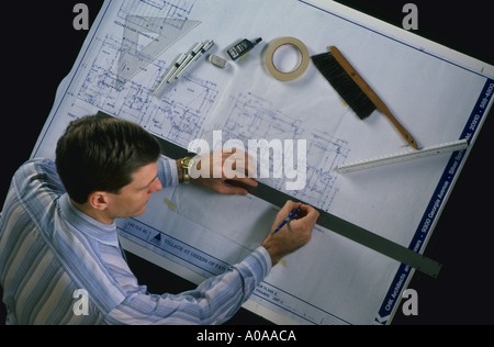 Man working as an architect at drawing board Stock Photo