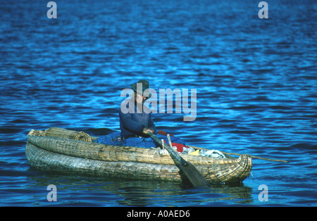 Uros Indigineous Peruvian Rowing a Reed Boat, Lake Titicaca, Peru Stock Photo