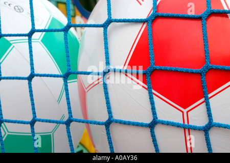 Inflatable footballs at fairground stall Stock Photo