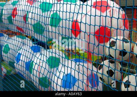 Inflatable footballs at fairground stall Stock Photo