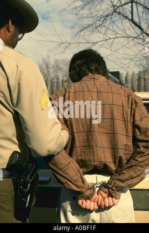 Policeman and man in handcuffs model released Stock Photo