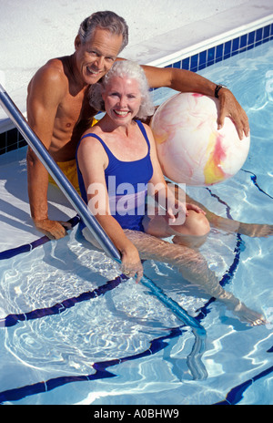 Portrait Caucasian senior couple in pool Stock Photo