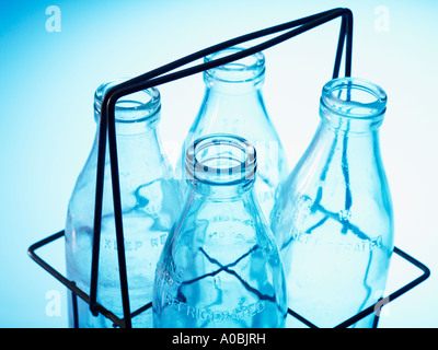 old milk bottles in wire holder Stock Photo