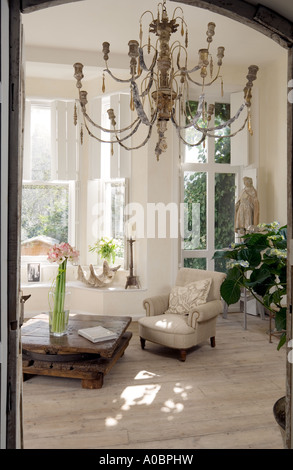 room view of white London interior with scrubbed timber floor and old French wooden chandelier Stock Photo