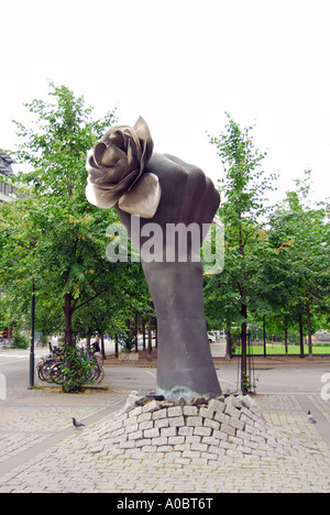 A monument of a fist punching up through the the brick ground with a rose in the hand City scene from Oslo Norway Stock Photo