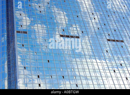 Clouds from the sky reflected in the windows of a highrise building in Oslo on a clear day Stock Photo