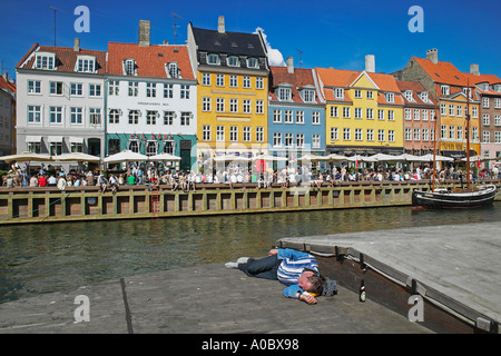 Drunk man sleeping on barge, Nyhavn, Copenhagen, Denmark Stock Photo