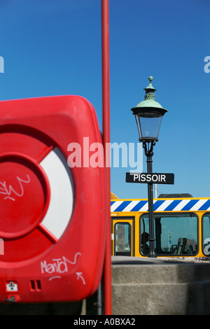 Red lifebelt box and pissoir public toilet sign, Nyhavn, Copenhagen, Denmark, Europe Stock Photo