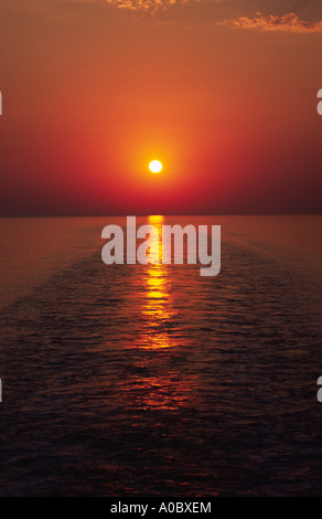 The setting sun on the Adriatic Sea, viewed from the stern of the Greek Ventouris ferry Siren Stock Photo