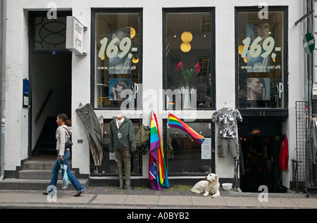 Hairdresser salon and sale of army surplus clothing on the pavement, Copenhagen, Denmark, Europe Stock Photo