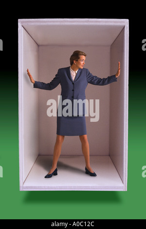 Businesswoman trapped in box Stock Photo